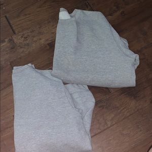 Two gray hoodless sweatshirt